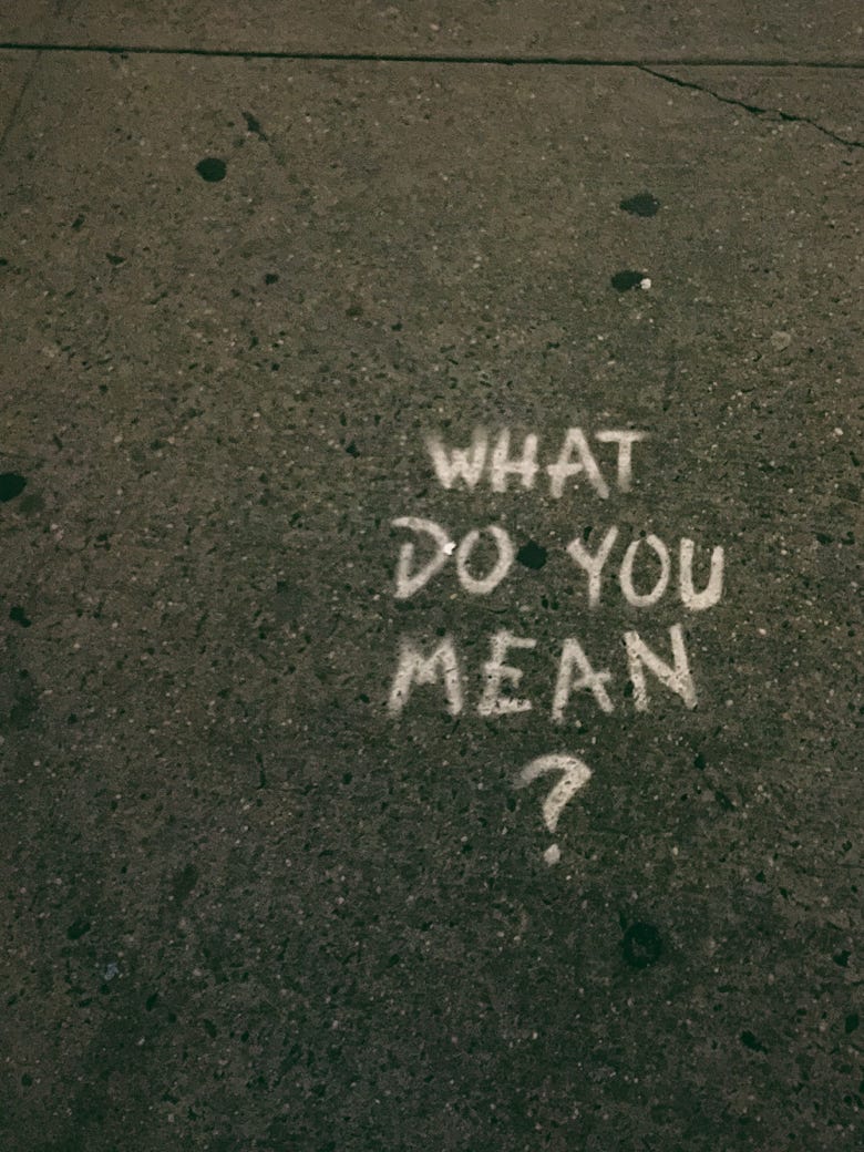 Image of What do you mean? graffiti on sidewalk, why do you need a consultant?